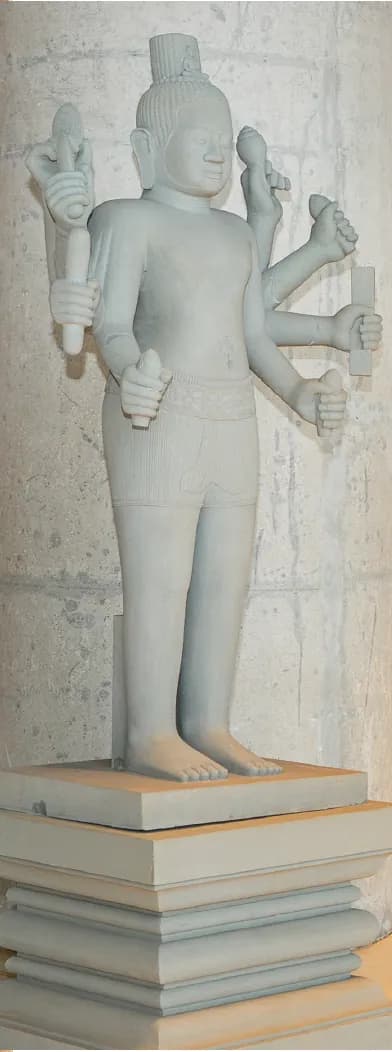 A stone statue of a many-armed figure