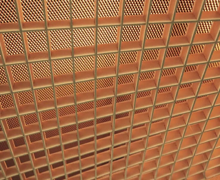 A latticed ceiling in warm light