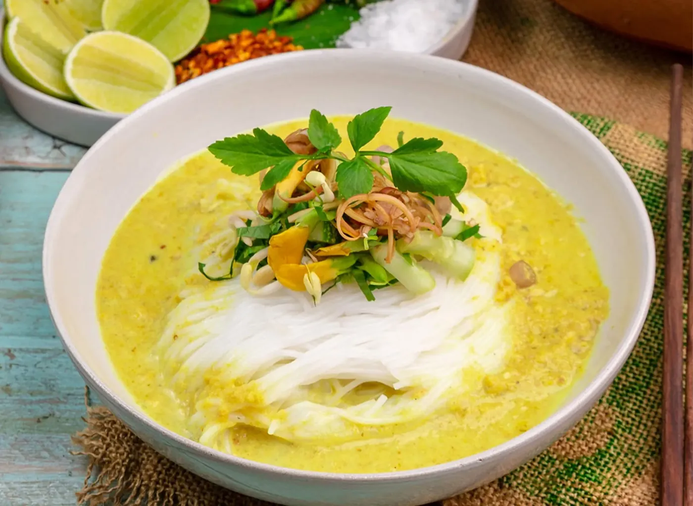 Rice noodles in a yellow curry with herbs
