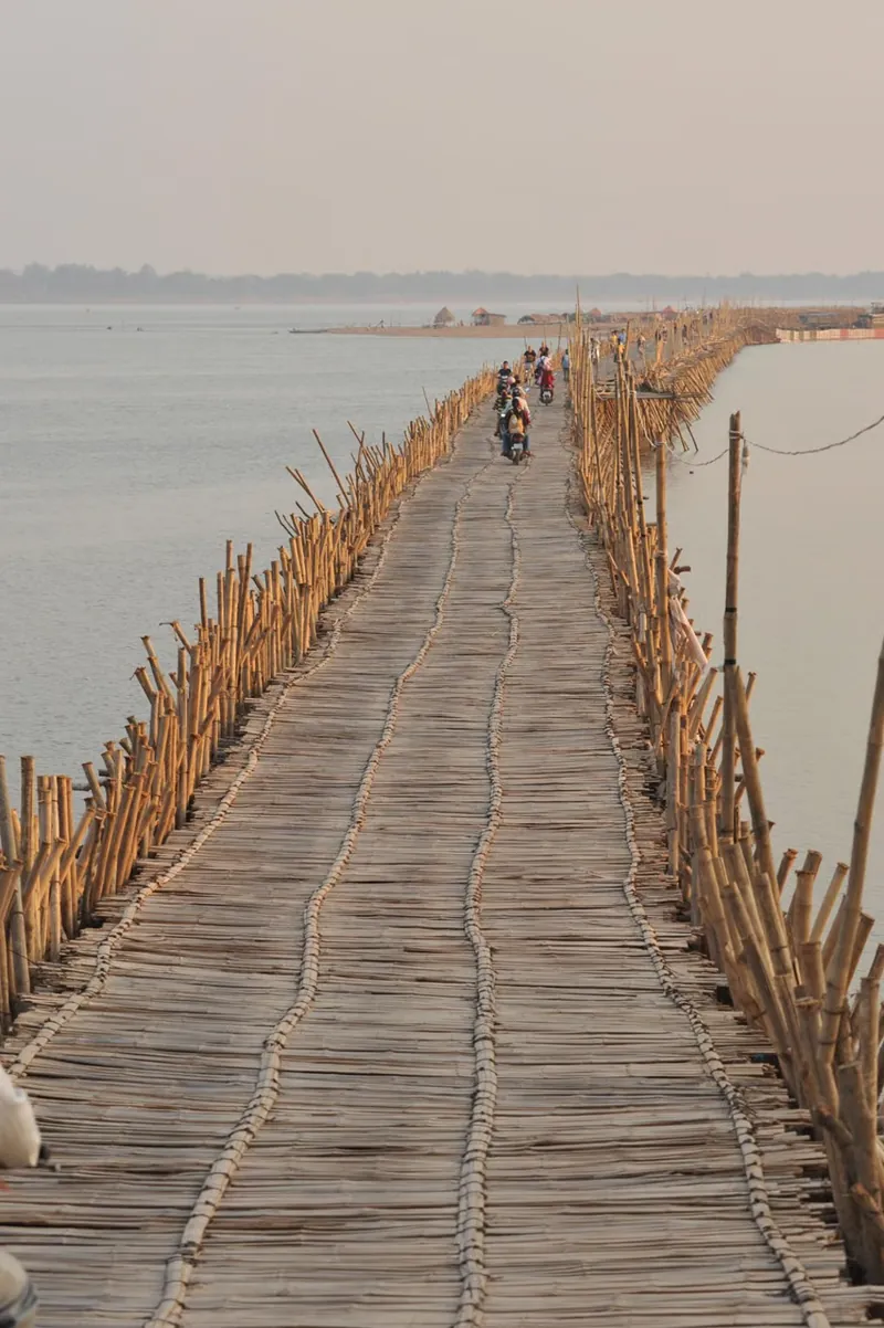 A long bamboo bridge crossing the river