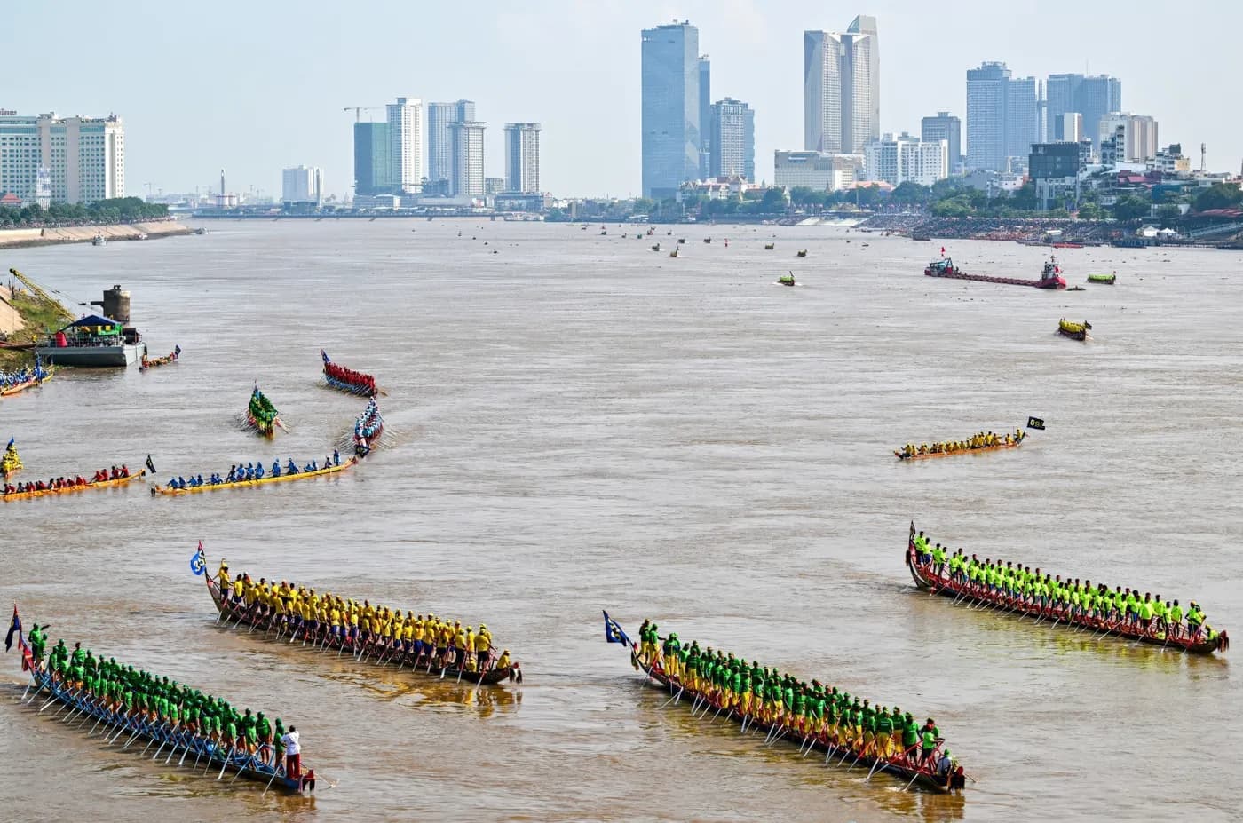 Longboats racing on the river below the city’s towers