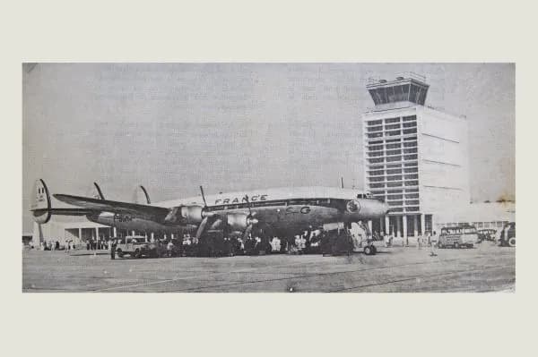 An airliner on the apron at Pochentong, with the control tower behind